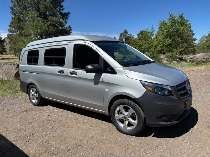 Silver Mercedes RV rental camper van on a dirt road, surrounded by trees under a sunny sky. — photo 12