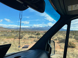 Scenic view from an RV rental, showing snow-capped mountains over a desert landscape. Perfect for a road trip adventure.