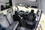 Ford Transit camper van interior: driver's cockpit, passenger seating, and rear storage shelf. Ideal for an RV rental adventure.