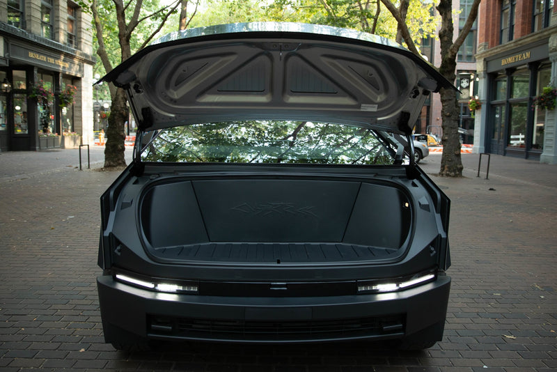 Rear view of dark, modern vehicle with trunk open, showing spacious cargo & bright LED lights. Great for your next RV rental trip. — photo 9