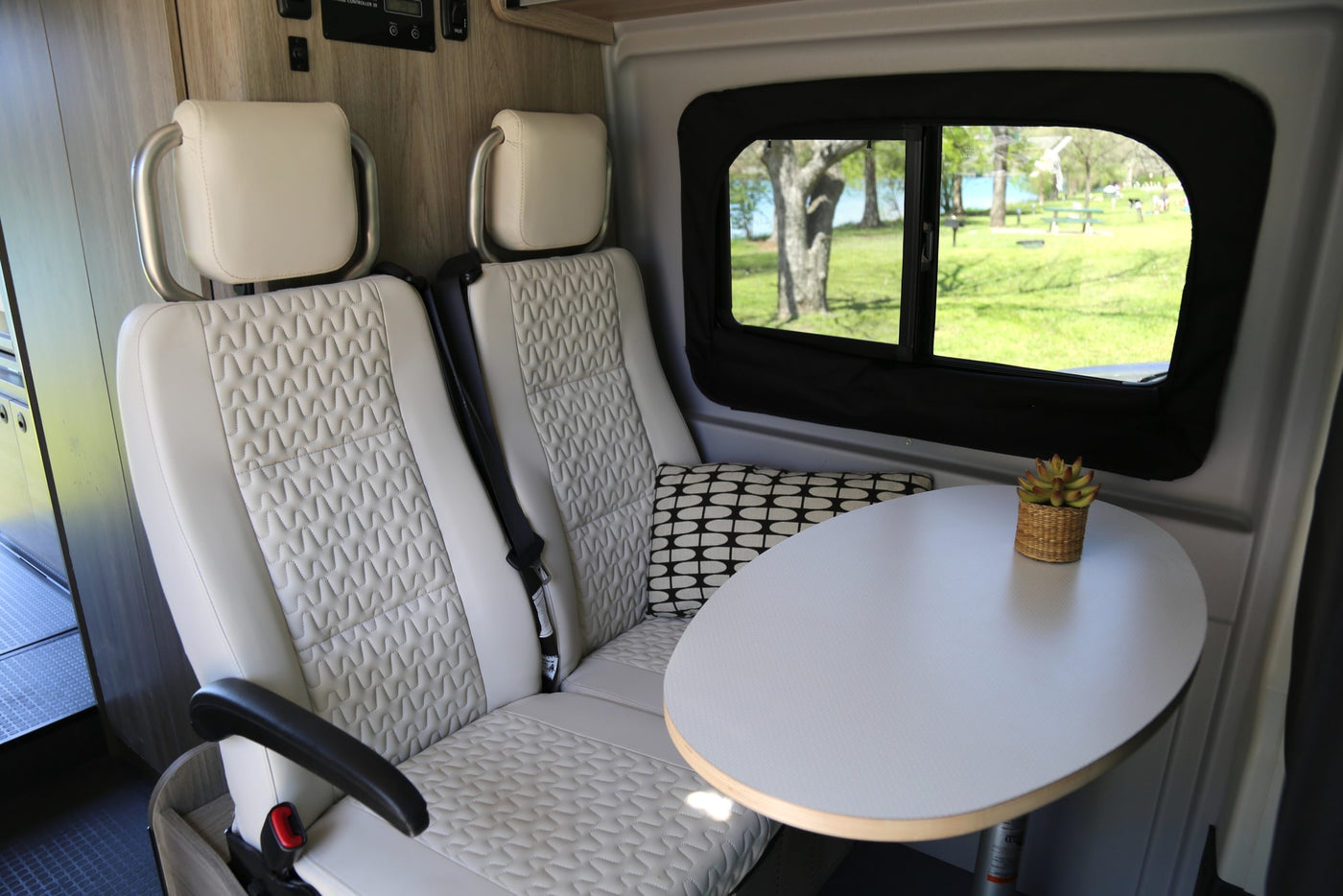  overlooking a serene lake.|White RV rental parked beside a tranquil lake with ducks on the grassy shore — photo 3