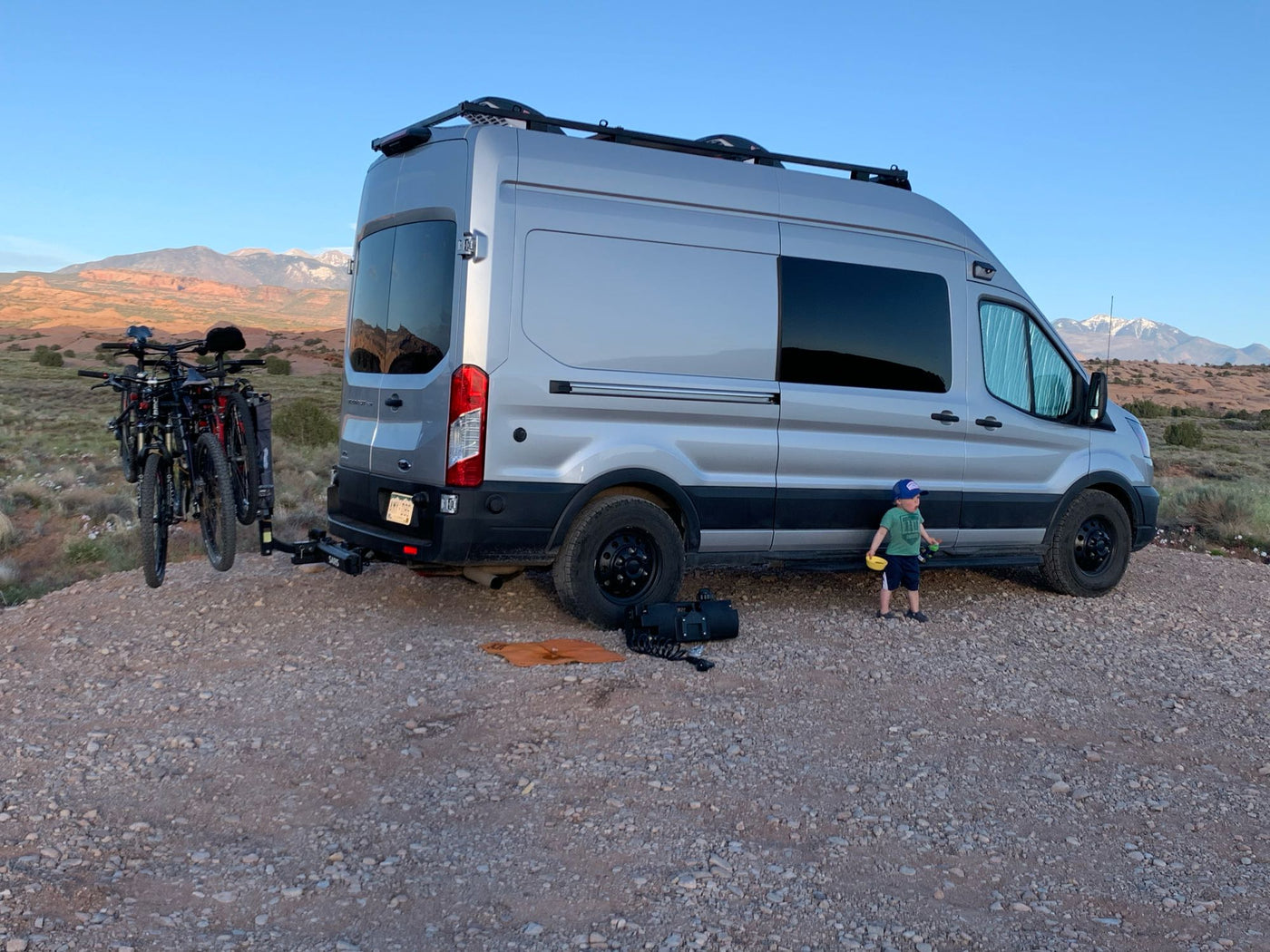  with roof rack and rugged tires.|Snow-covered RV rental van parked in deep snow during a nighttime blizzard — photo 2