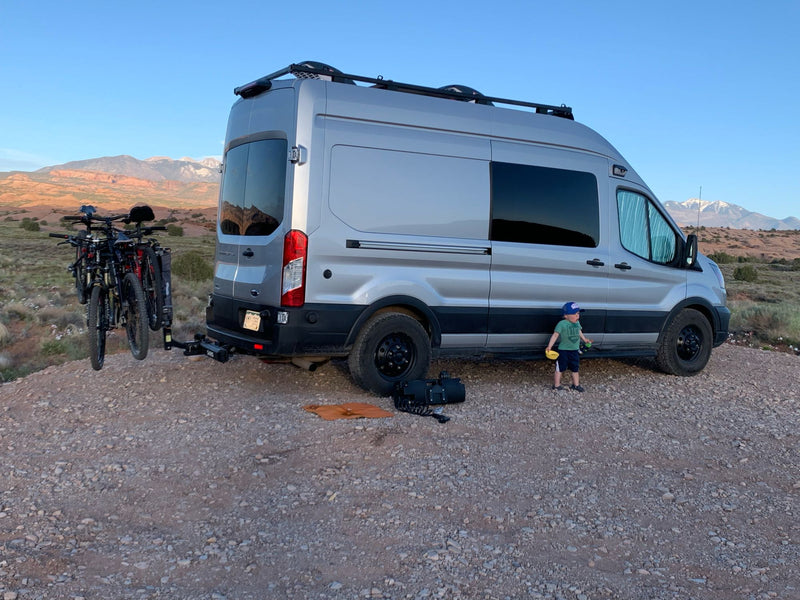  with roof rack and rugged tires.|Snow-covered RV rental van parked in deep snow during a nighttime blizzard — photo 2