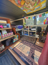 Cozy, customized rv rental interior: organized storage, comfortable bed, and unique decor for your next adventure.