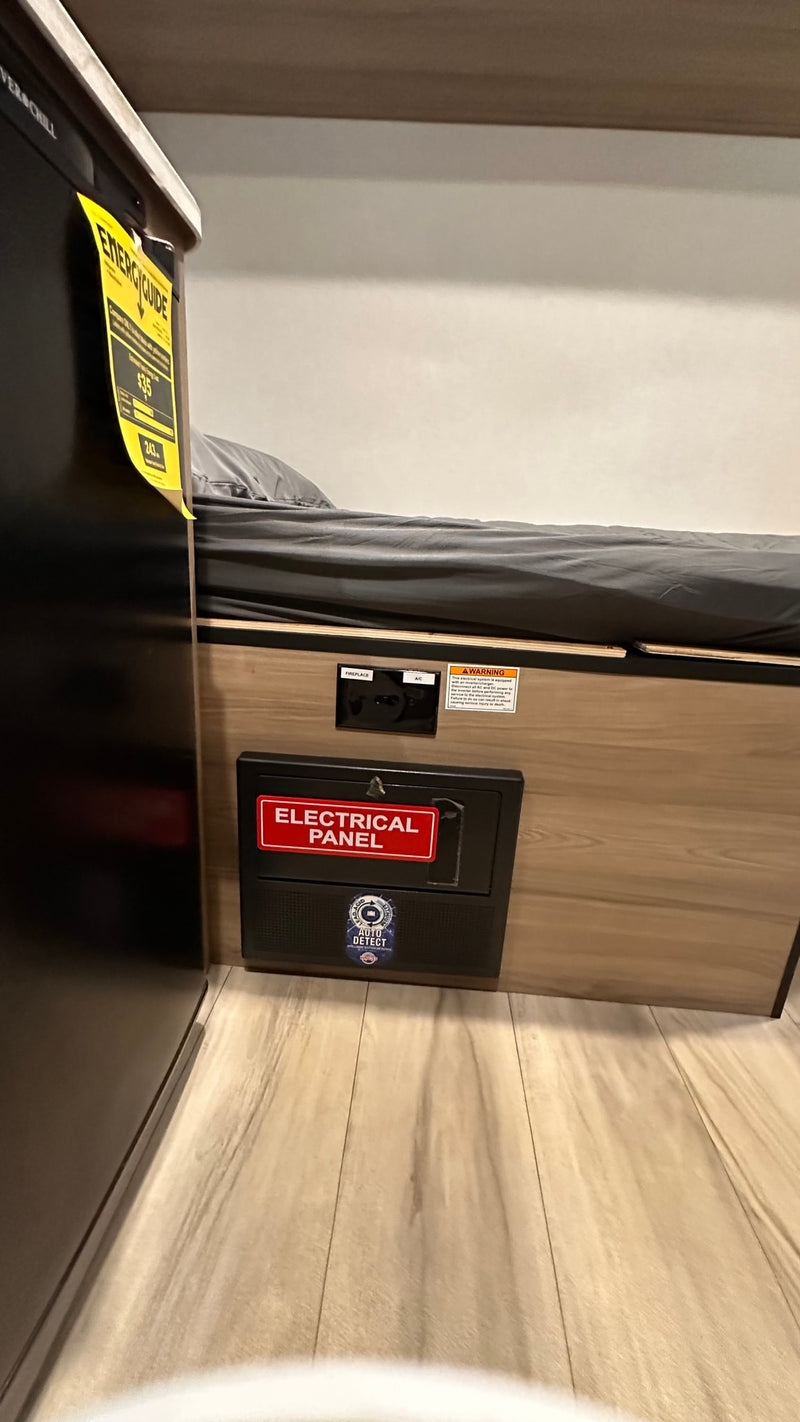  and controls. Safety includes an extinguisher by the exit.|RV rental's cozy interior: bunk bed — photo 16