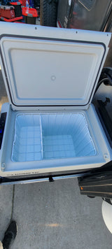 Open Dometic portable fridge/freezer on a slide-out, ready for your RV rental camping adventure.
