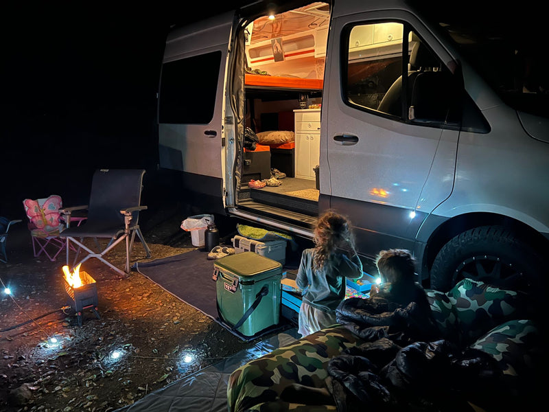  showcasing a beautiful sunset over hills.|Adventure-ready Sprinter van RV rental parked on a scenic dirt road — photo 7