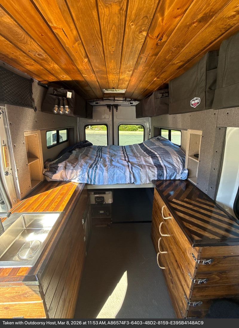  and outdoor gear for adventure.|Compact RV rental kitchen area: wooden countertop — photo 9