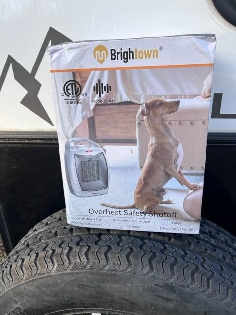Brightown portable heater box, highlighting safety features, pictured by a tire, ideal for an RV rental. — photo 12