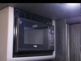 This image shows a sleek, compact microwave in an RV rental, providing convenient cooking.