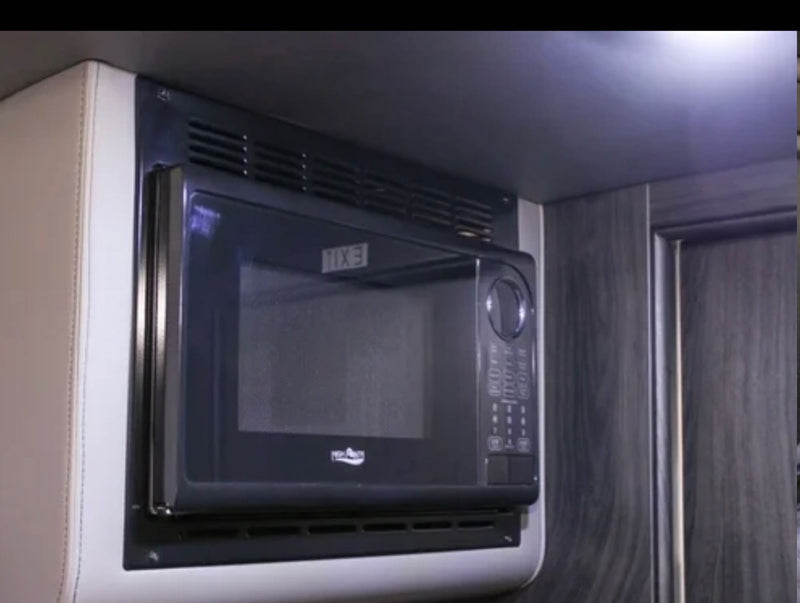 This image shows a sleek, compact microwave in an RV rental, providing convenient cooking. — photo 18