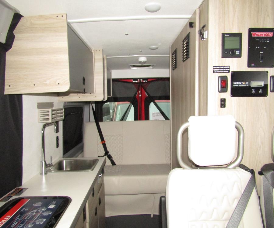  and a convenient privacy curtain.|Pet-friendly RV rental: A merle Australian Shepherd sits inside — photo 6