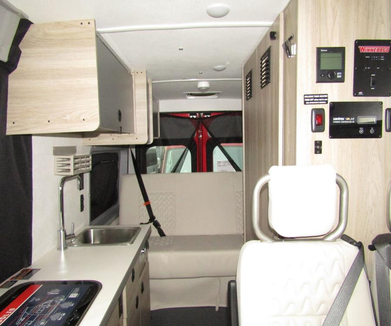  and a convenient privacy curtain.|Pet-friendly RV rental: A merle Australian Shepherd sits inside — photo 6