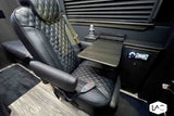 Plush rv rental interior features a black quilted captain's seat with remote, side table, and entertainment.