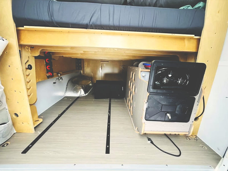  and bamboo overhead cabinets for storage.|RV rental interior: custom camper kitchen featuring a two-burner stove — photo 13