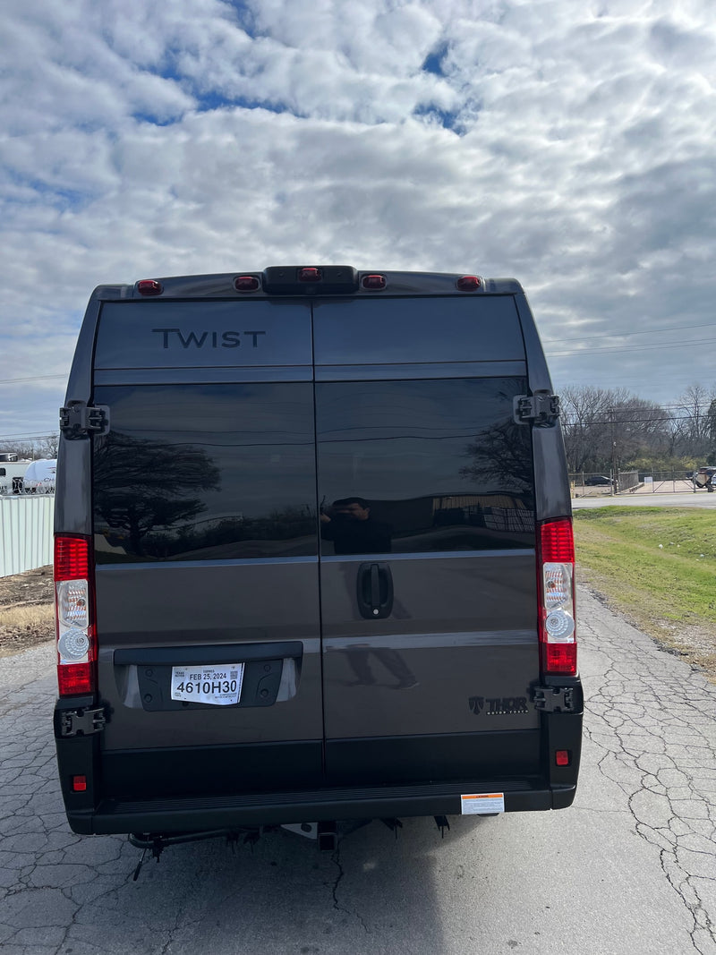 Rear of a dark gray Thor Twist camper van, a great RV rental option. Features a Texas temporary tag. — photo 3