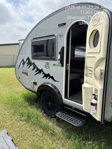 NuCamp T@B 320 Boondock teardrop RV rental with open door, parked on grass in Sherman, TX.