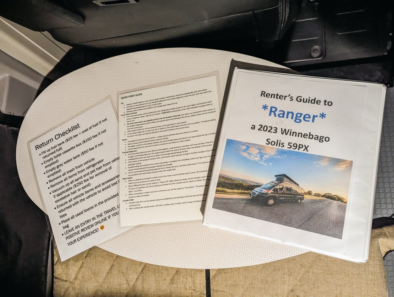 An RV rental guide and return checklist for a Winnebago Solis are displayed, showing rental procedures and quick tips.