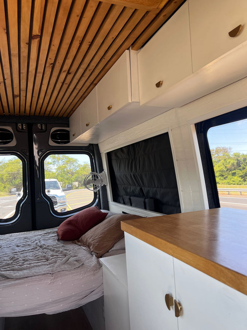  parked at a scenic campsite with mountains in golden hour light.|Golden sunset reflects beautifully on this Mercedes Sprinter **RV rental** van — photo 9