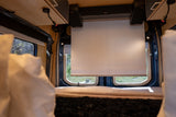 Experience an RV rental! Van interior with a pull-down screen, speakers, and comfy bed for a cozy mobile entertainment setup.