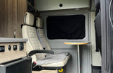 RV rental interior: passenger seats, table, and power controls for comfortable travel.
