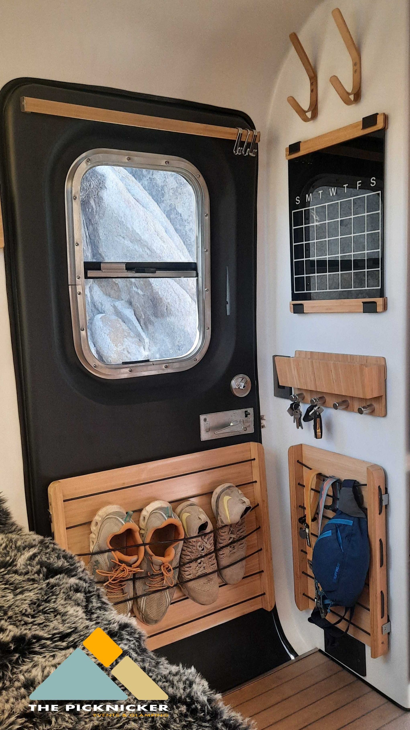 Smart RV rental interior with compact storage solutions: door, calendar, key rack, shoe organizer, and gear hooks. Ready for adventure! — photo 16