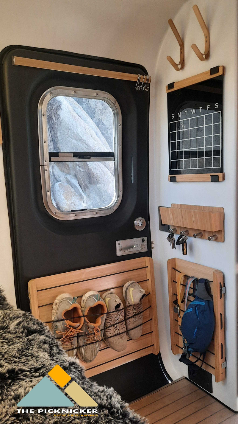 Smart RV rental interior with compact storage solutions: door, calendar, key rack, shoe organizer, and gear hooks. Ready for adventure! — photo 16