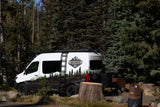 High Country RV rental camper van at a forest campsite. Ready for outdoor adventure and nature exploration.