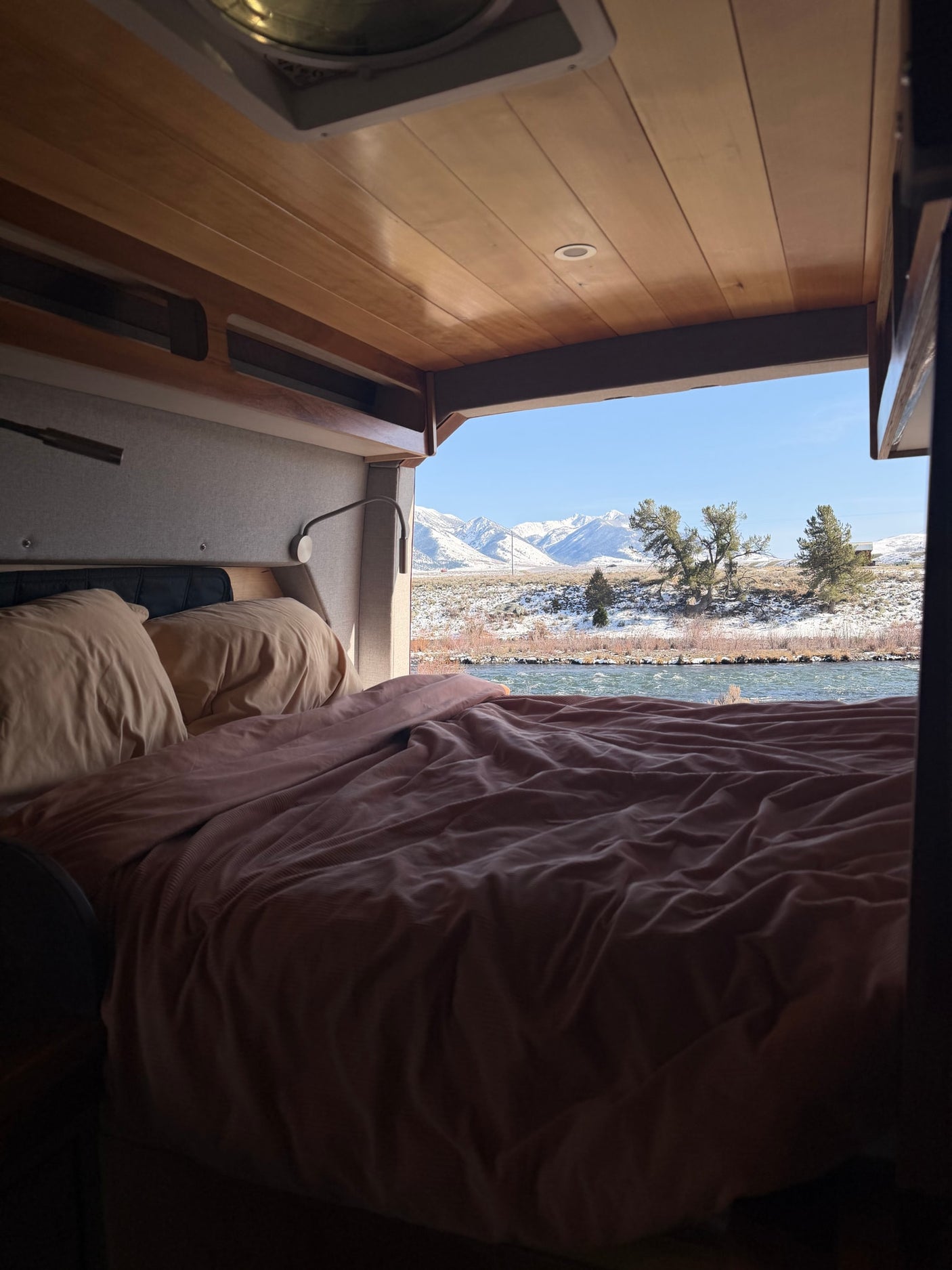  and blue cushioned seating.|Explore this cozy RV rental's clever camper van interior