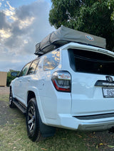 White Toyota 4Runner SUV equipped with a rooftop tent, offering an RV rental alternative for outdoor adventures.