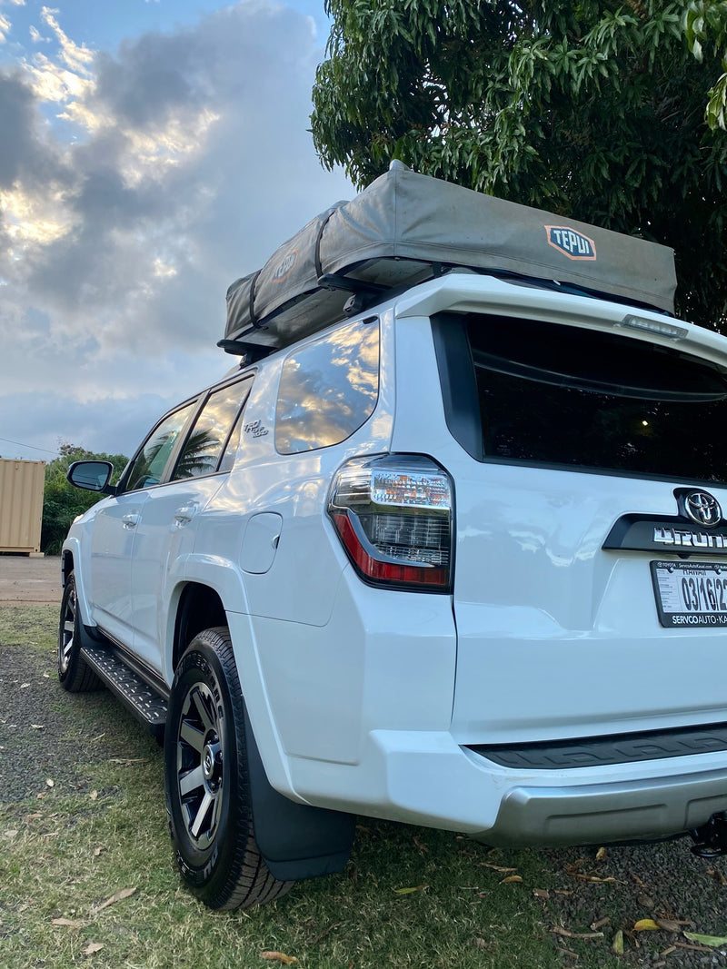 White Toyota 4Runner SUV equipped with a rooftop tent, offering an RV rental alternative for outdoor adventures. — photo 11