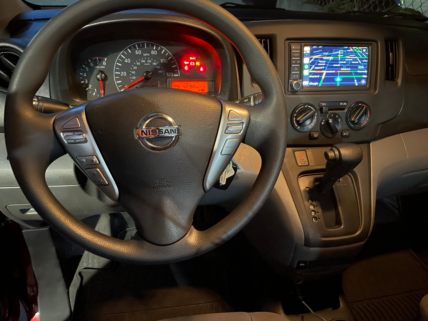 Nissan RV rental interior showing dashboard with 5219.3 miles, steering wheel, and navigation screen.