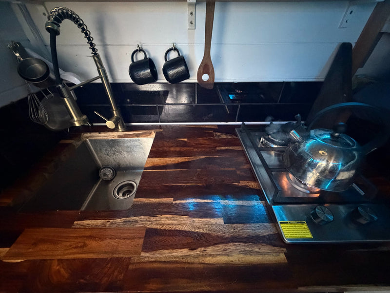  and a black geometric rug.|White Ford F-350 truck with a custom black overland truck camper — photo 6