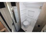 RV rental: Compact RV wet bath with toilet, shower, and a partial view of a sink on the left.
