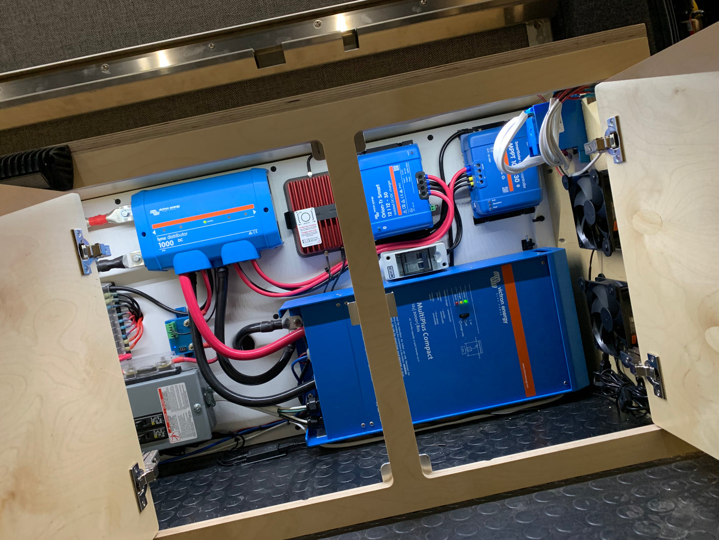 RV rental's advanced electrical system: Victron Energy Lynx, Orion-Tr, SmartSolar, MultiPlus Compact inverter/charger, and wiring.