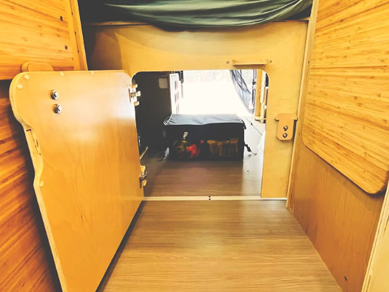  and clever storage solutions.|Cozy RV rental interior: wide bed with soft green bedding — photo 11