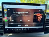 This RV rental's Apple CarPlay displays "On the Road Again" by Willie Nelson, with outside 84° and inside AC at 73°.