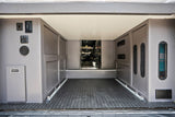 RV rental's rear utility area: power outlets, water/light controls, drain, vents, & floor tie-downs for secure cargo.