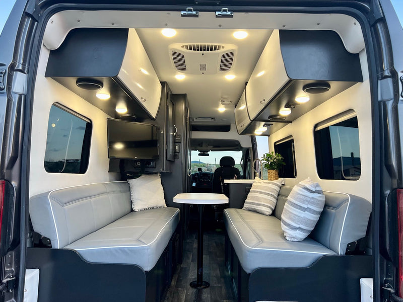  modern rv rental interior showcasing grey benches — photo 13