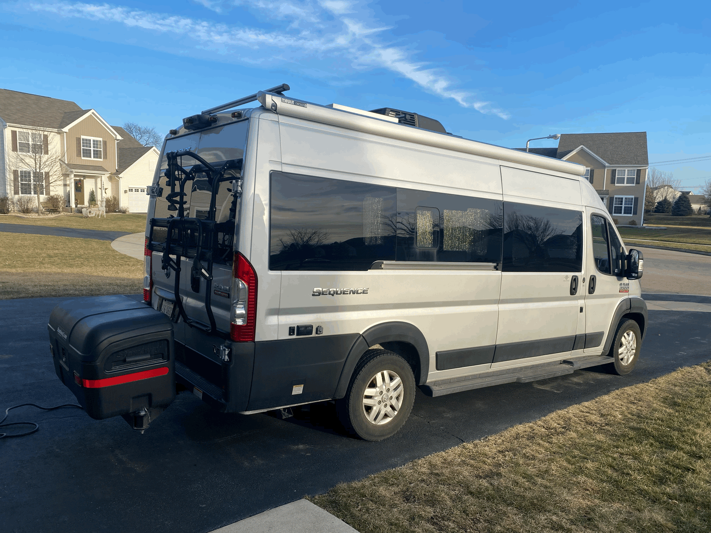 This RV rental Thor Sequence camper van is equipped with a bike rack, rear storage, and roof awning, ready for adventure.