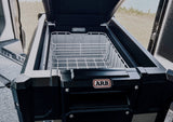 ARB portable fridge/freezer open in an RV rental, essential for fresh food on your road trip or camping adventures.