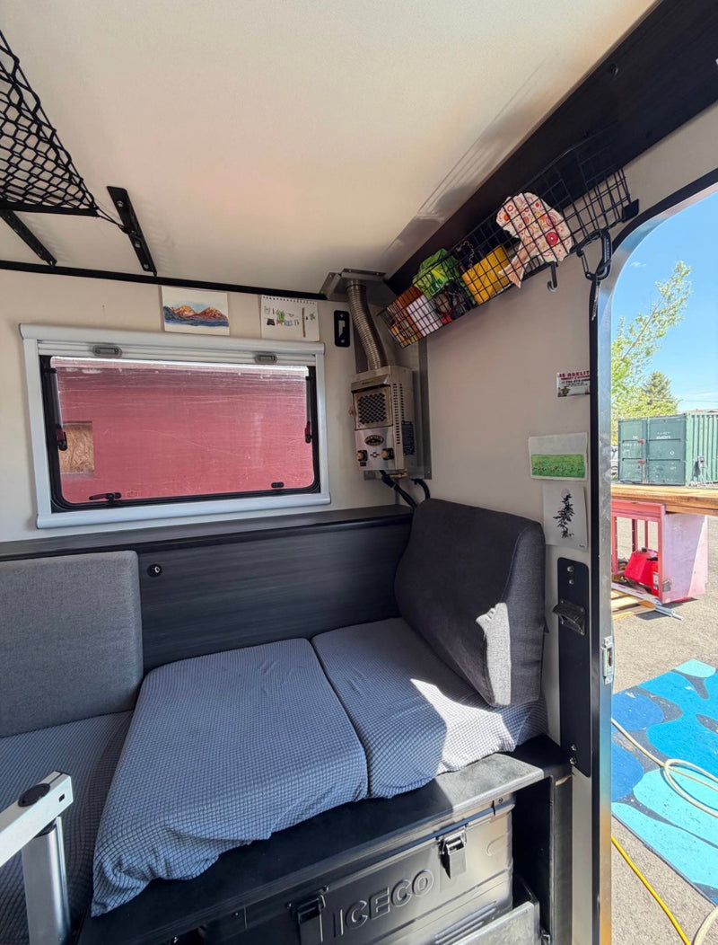  ready for your RV rental adventure.|An rv rental's organized interior shows an elevated bed — photo 4