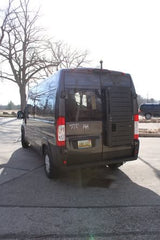 Ram ProMaster van, ideal for rv rental, showing its rear lift & accessible design. Parked on a sunny day.