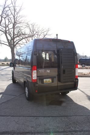 Ram ProMaster van, ideal for rv rental, showing its rear lift & accessible design. Parked on a sunny day.