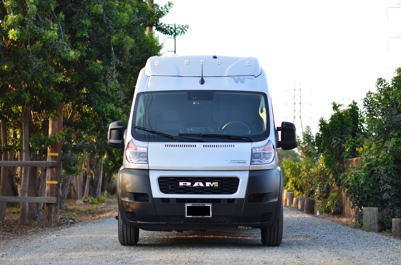 Front view of a white Winnebago Ram ProMaster camper van, an ideal RV rental for outdoor adventures.