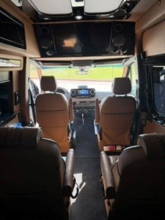 perfect for comfortable group travel.|Experience luxury RV rental travel! Plush tan quilted bench seating with black piping — photo 10