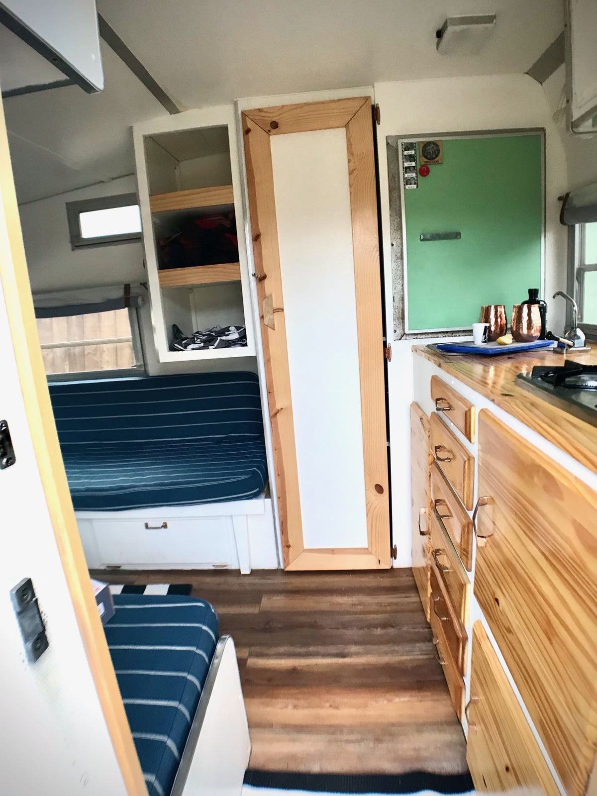  detailing features of this classic RV. Ideal for an rv rental nostalgic trip.|A white vintage travel trailer — photo 8