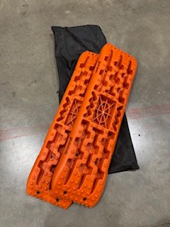 RV rental adventure essential! Bright orange traction boards for off-road recovery, helping you get unstuck from mud, sand, or snow.