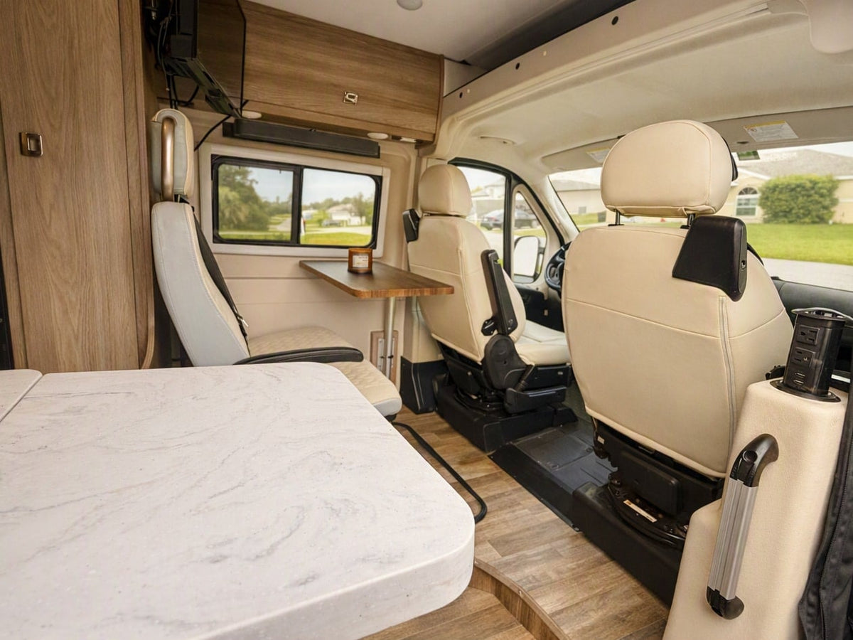  and a campfire set up in a forest campsite.|RV rental floor plan (model 59G) with bed — photo 4