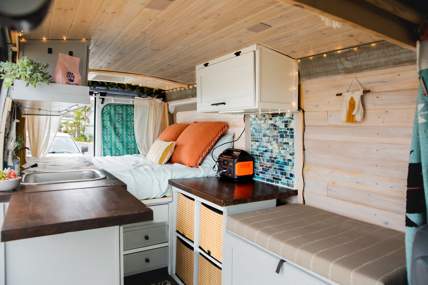 Experience mobile living in this cozy RV rental! Features a comfy bed, compact kitchen, storage, and ambient lighting. Ideal camper van. — photo 6
